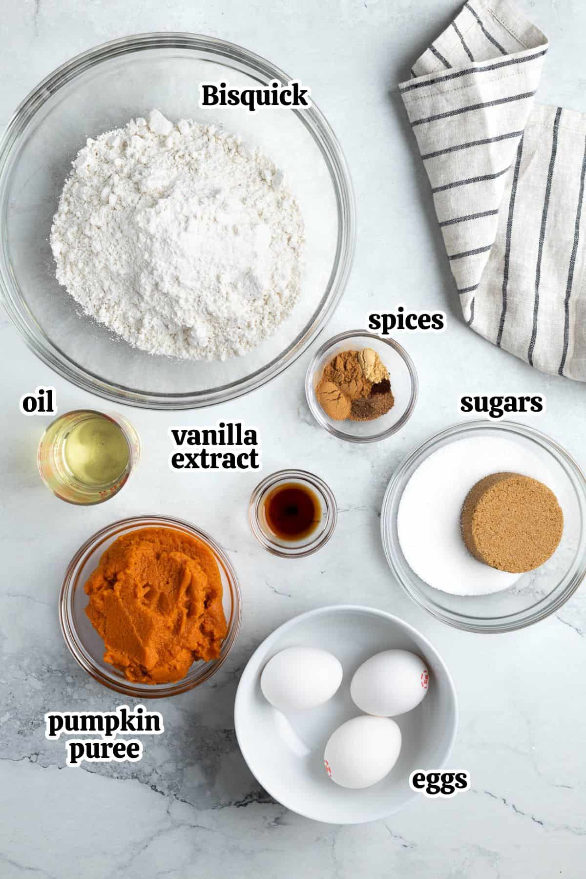 Text-labeled pumpkin bread ingredients in separate bowls.