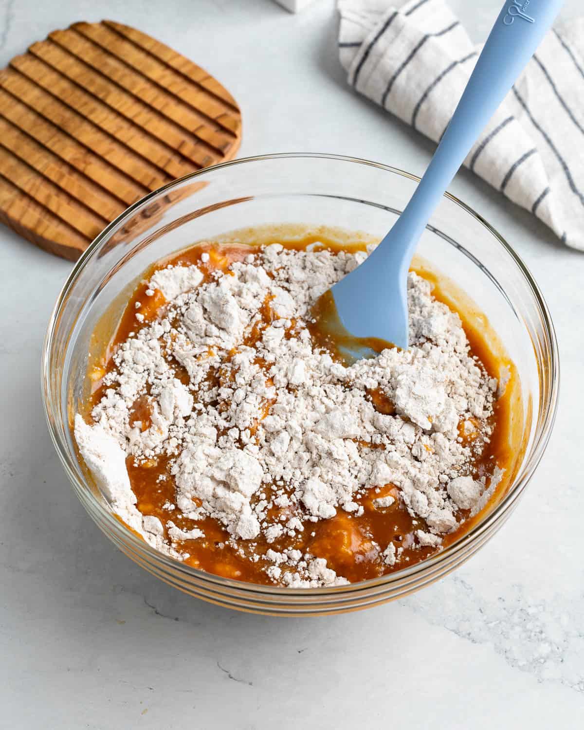 The wet and dry ingredients being stirred together in a bowl.