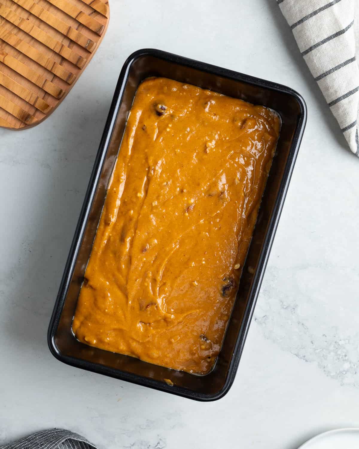 The batter poured into a loaf pan.