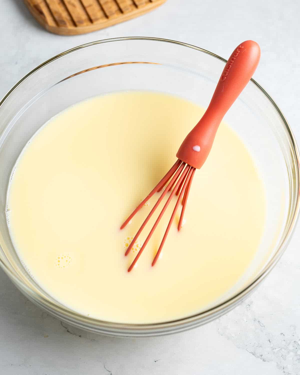 All liquid ingredients whisked together in a glass bowl.