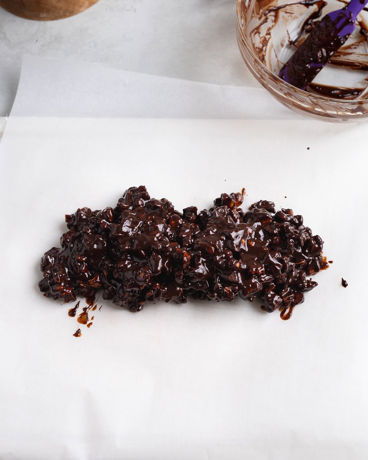 The ganache/biscuit/nut mixture turned out onto a large sheet of parchment paper.