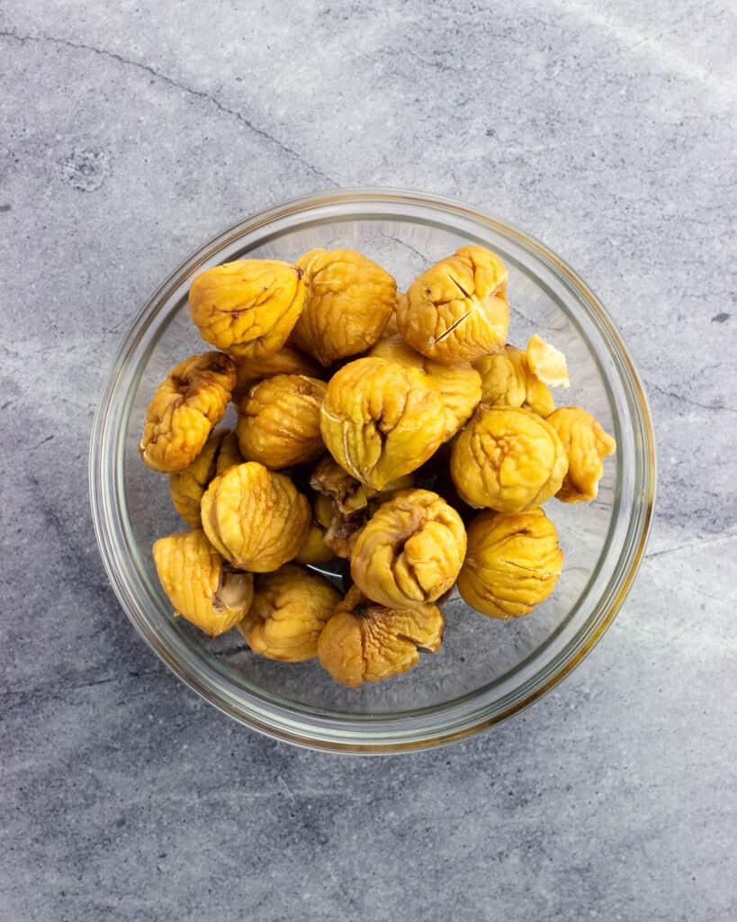 Roasted and peeled whole chestnuts in a bowl.