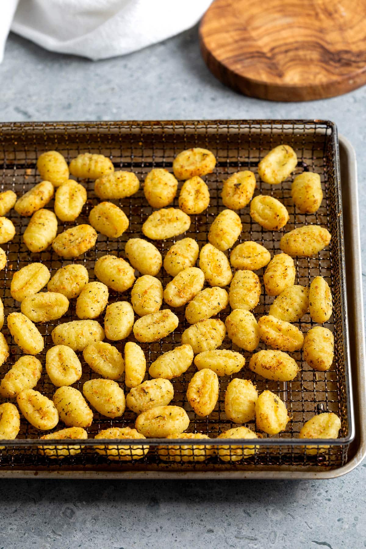 Air fried gnocchi on a wire air fryer basket.