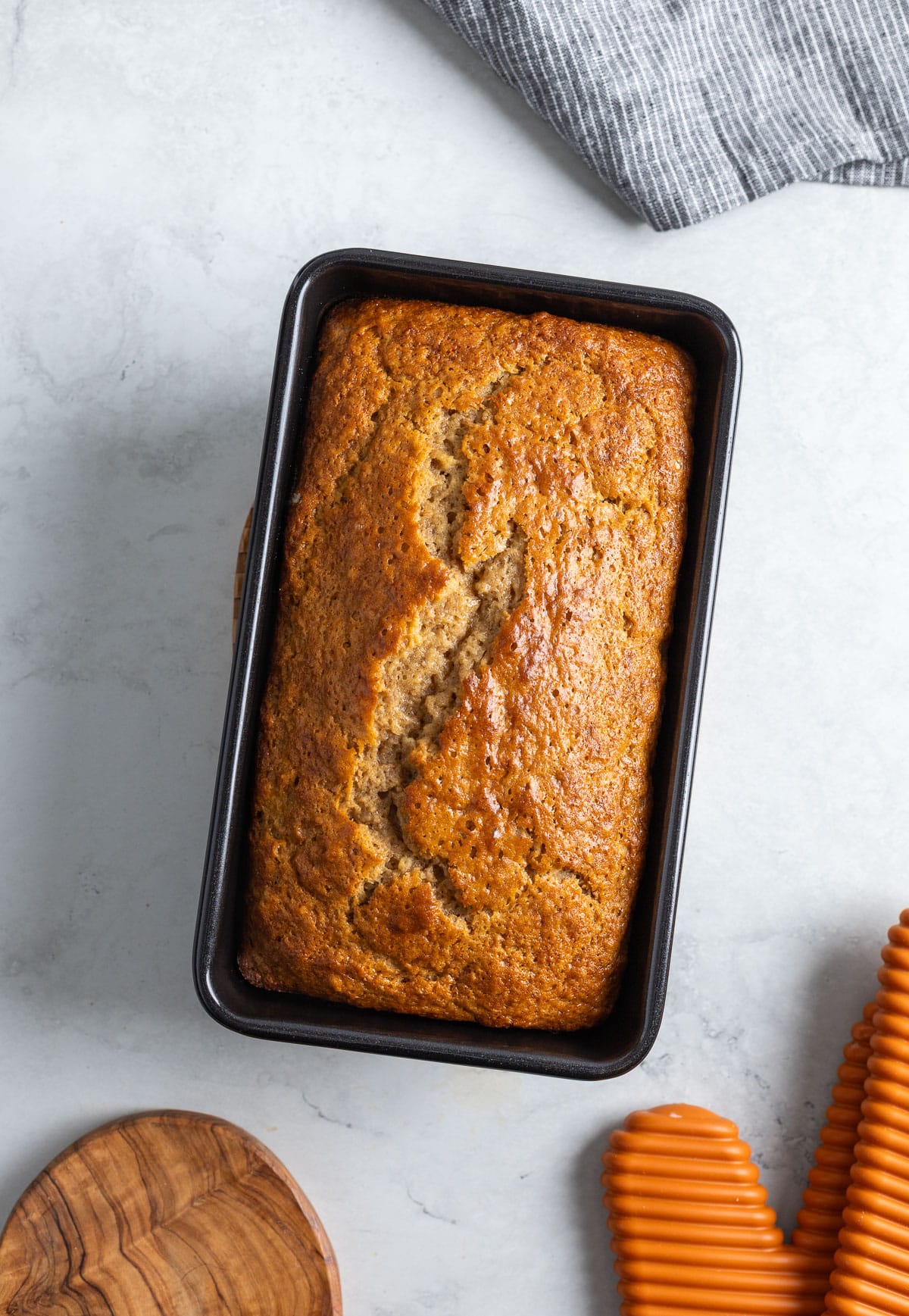 Baked banana bread in a loaf pan.