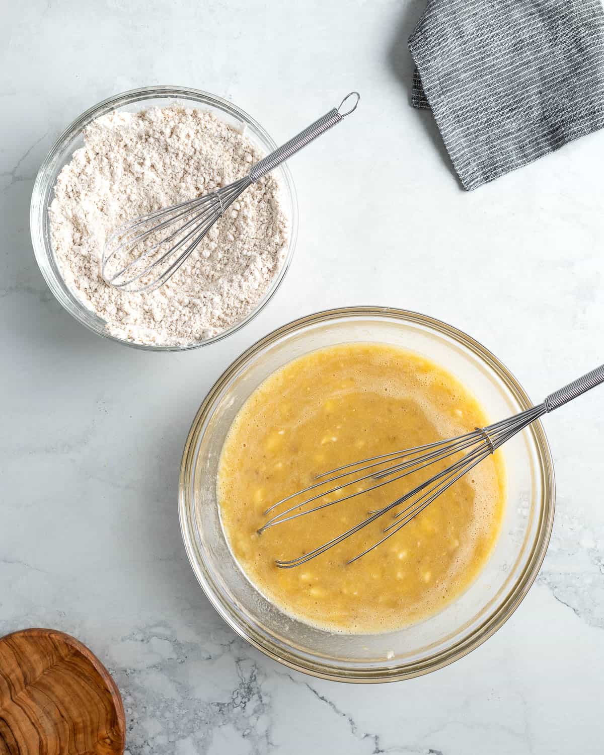 Wet and dry ingredients mixed together in separate bowls.