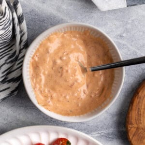 Spicy Calabrian aioli mixed in a bowl with a spoon.