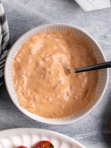 Spicy Calabrian aioli mixed in a bowl with a spoon.