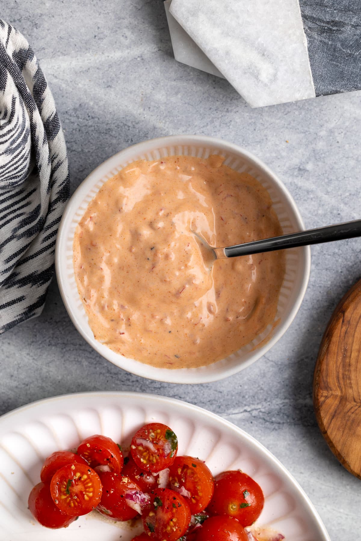 Spicy Calabrian aioli mixed in a bowl with a spoon.