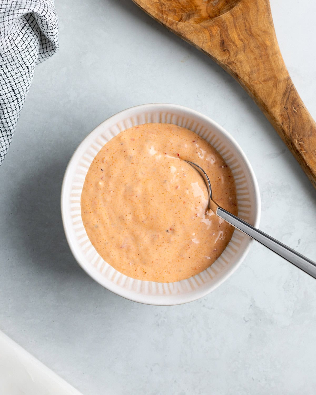 Calabrian chili aioli stirred together in a bowl.