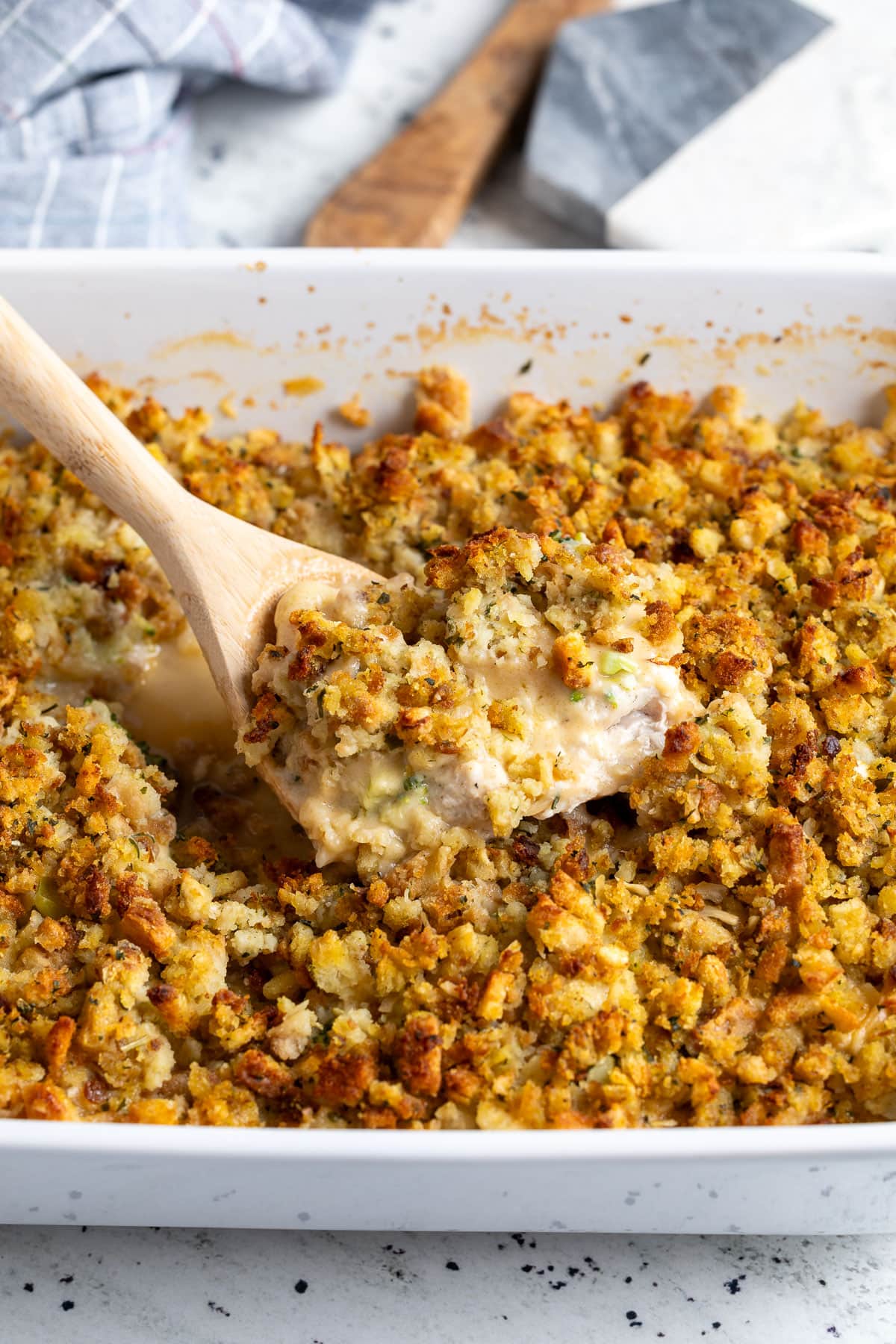 A portion of the stuffing chicken casserole being lifted out of the pan.