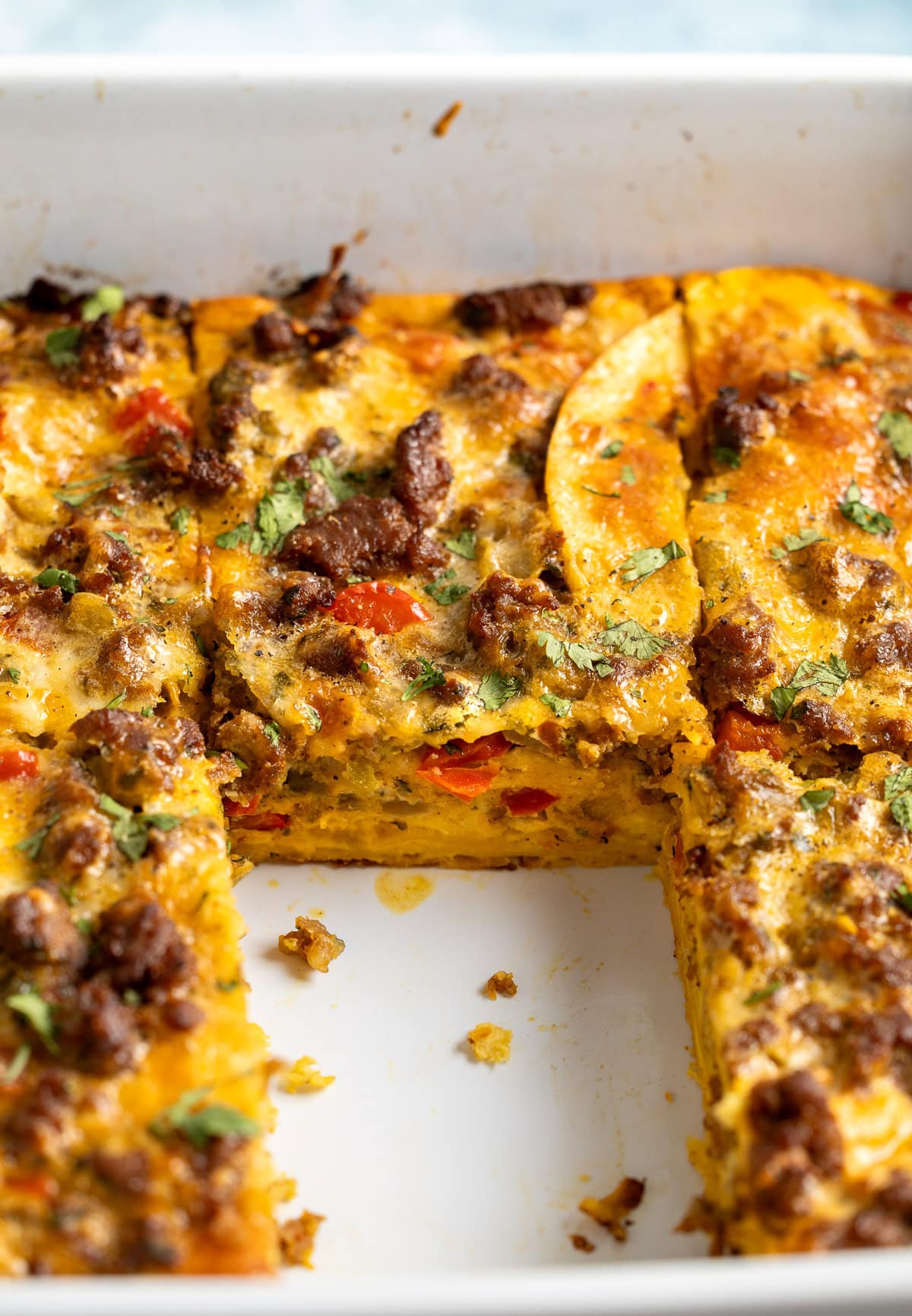 A side view of the chorizo egg casserole in the pan once a slice had been removed.