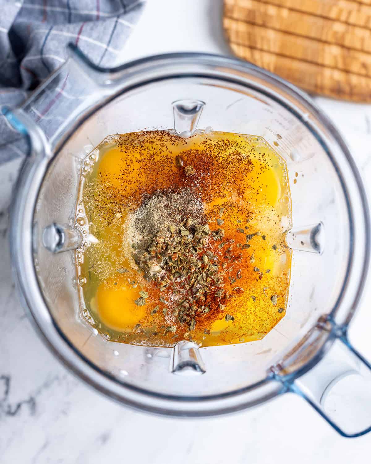 The eggs, cottage cheese, milk, and spices added to a blender.