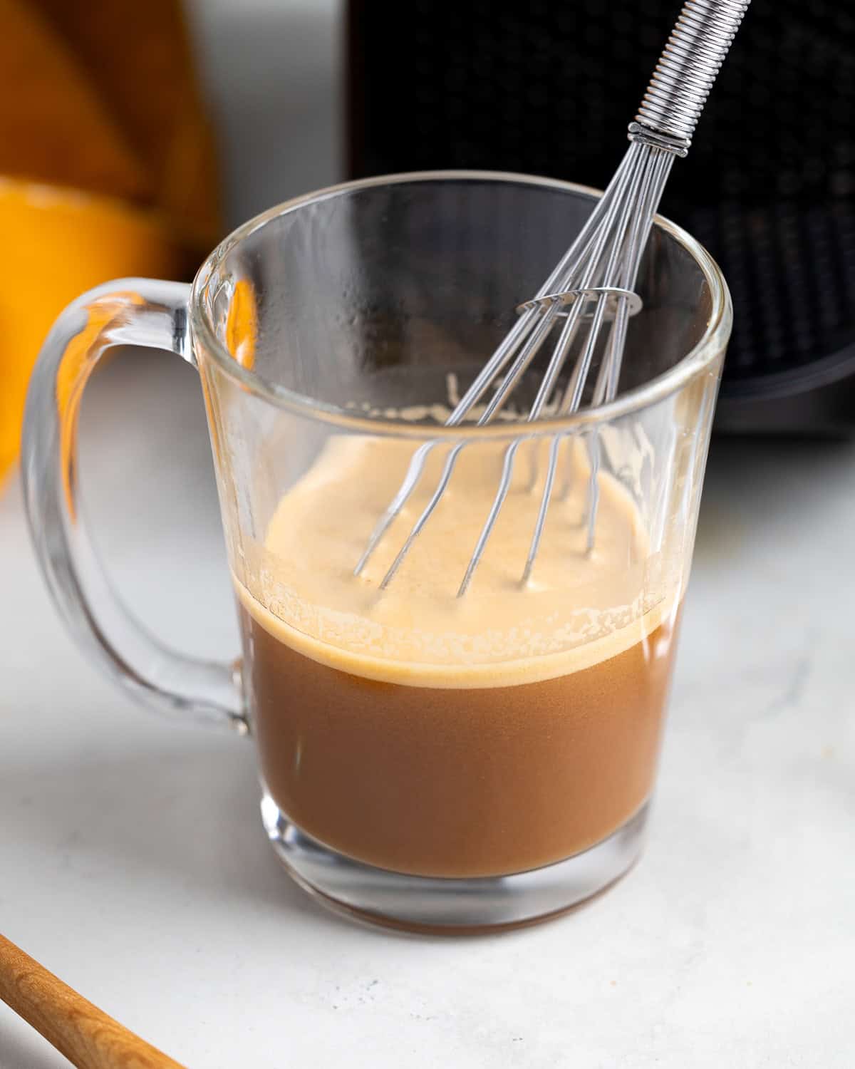 A small whisk in the mug of espresso to dissolve the cookie butter.