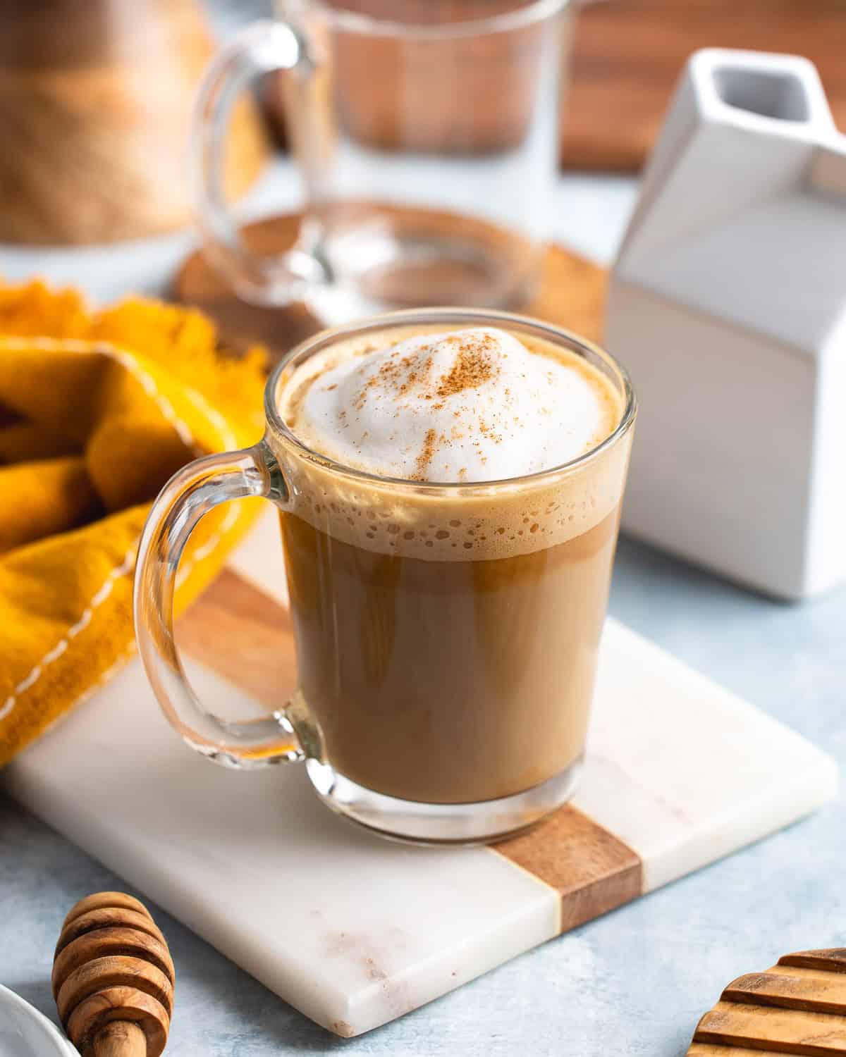 The steamed milk poured into the mug to finish the cookie butter latte.