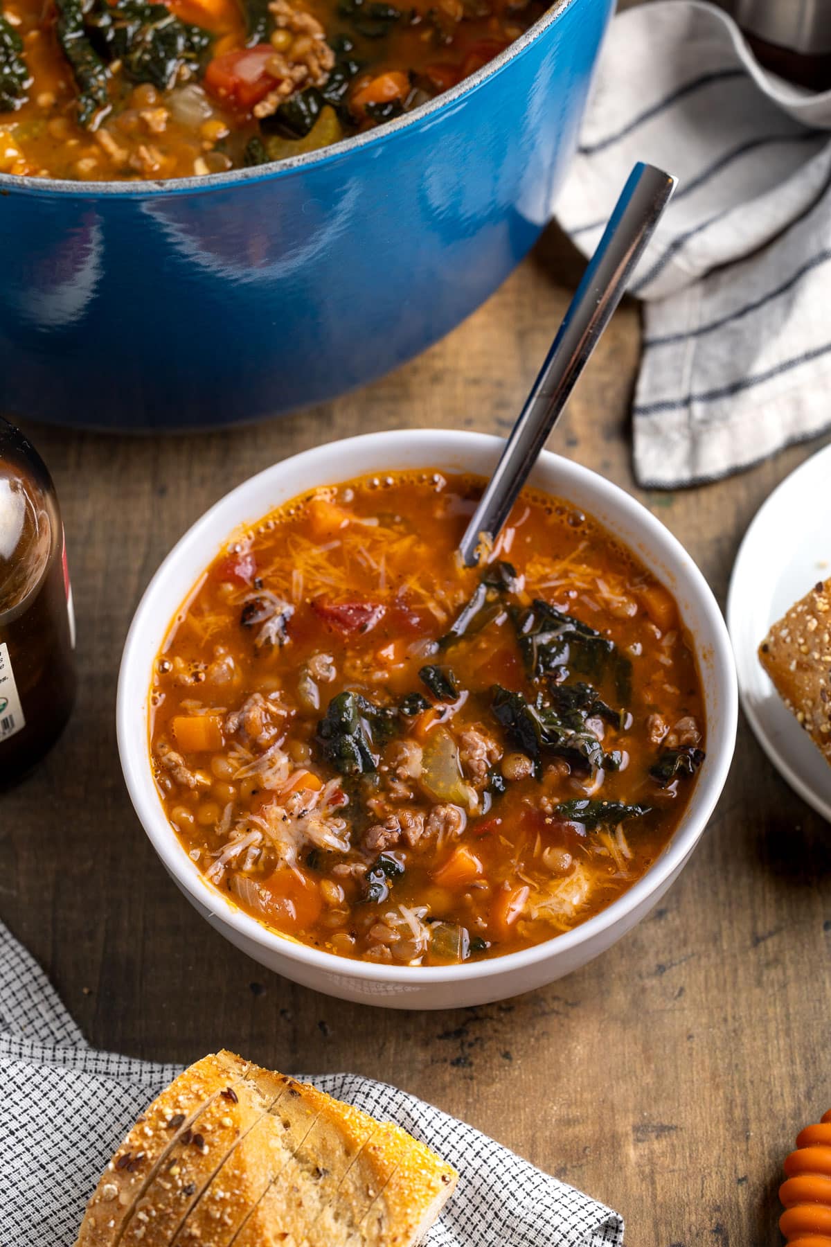 A bowl of soup with a spoon in it.