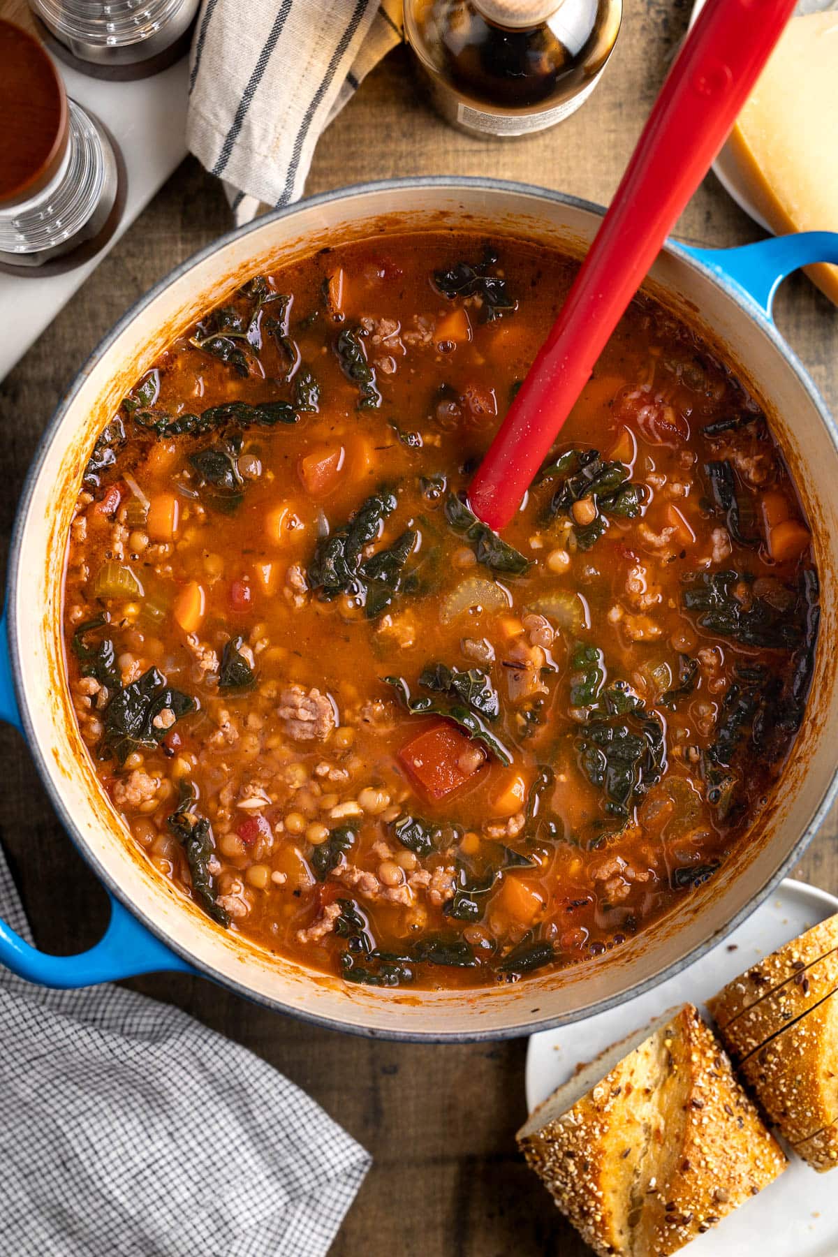 A Dutch oven of Italian lentil soup with spinach.
