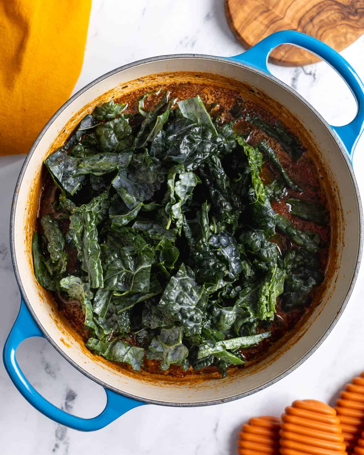 Chopped kale added to the soup pot.