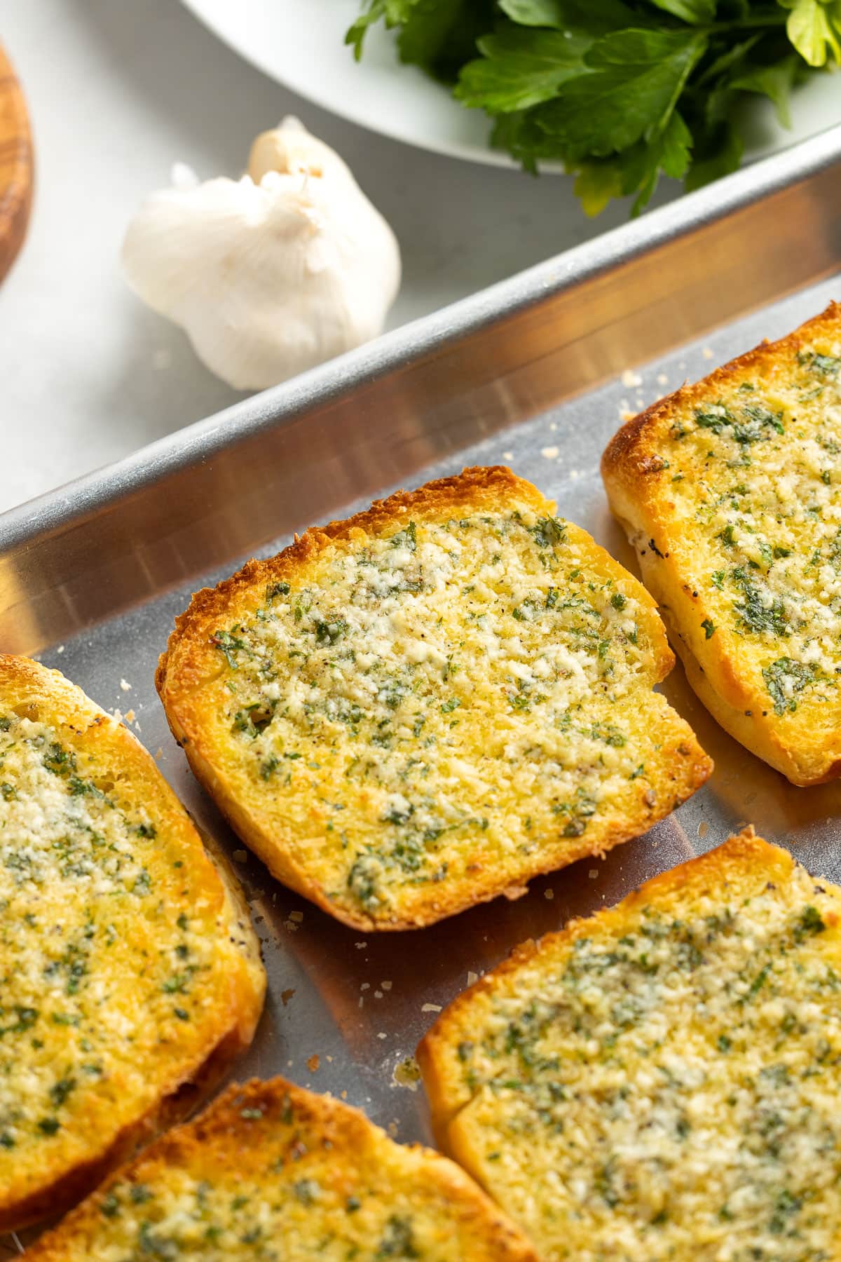 Broiled until crisp onion garlic bread on a pan.