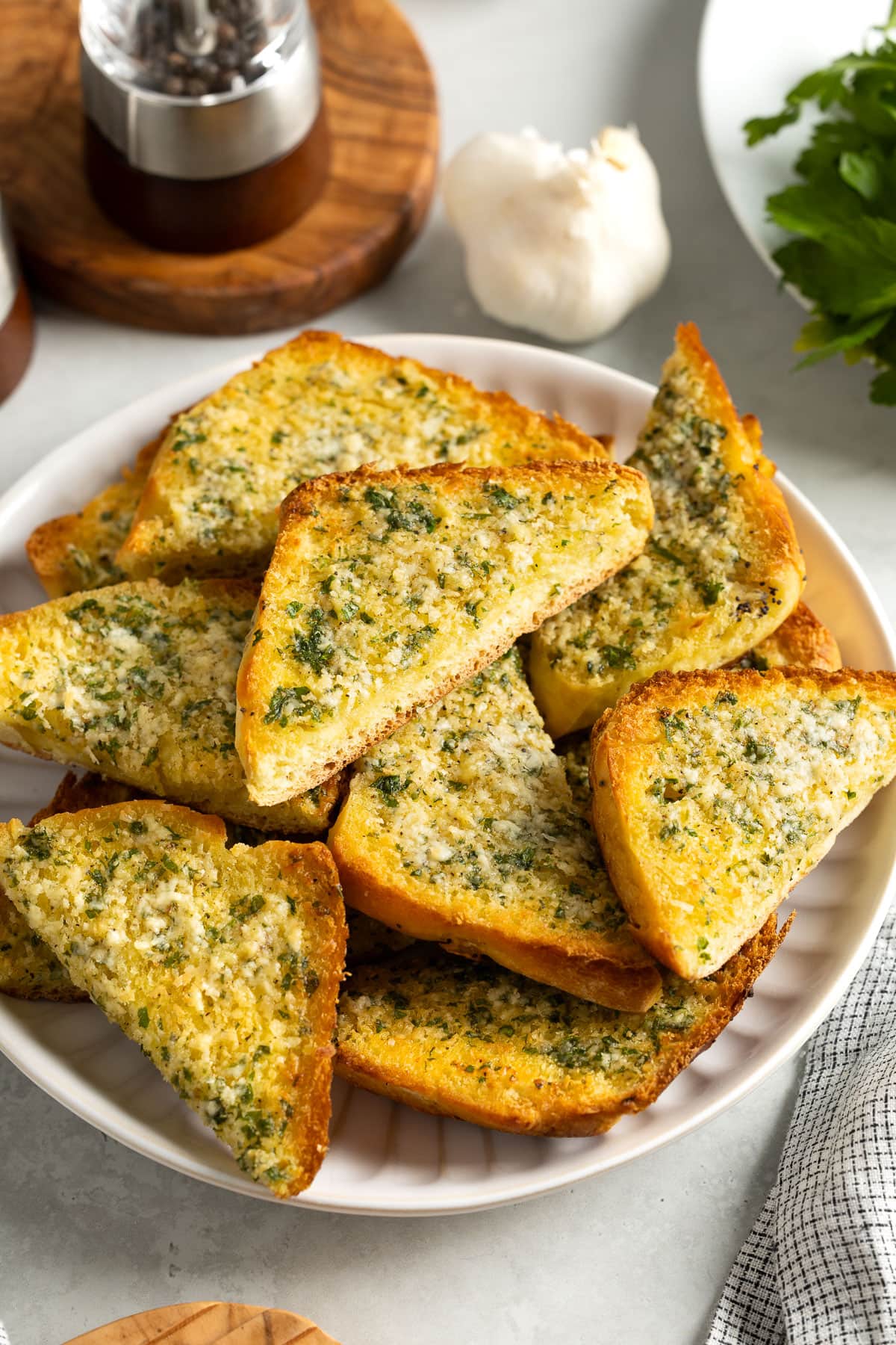Wedges of sliced onion garlic bread on a plate to serve.