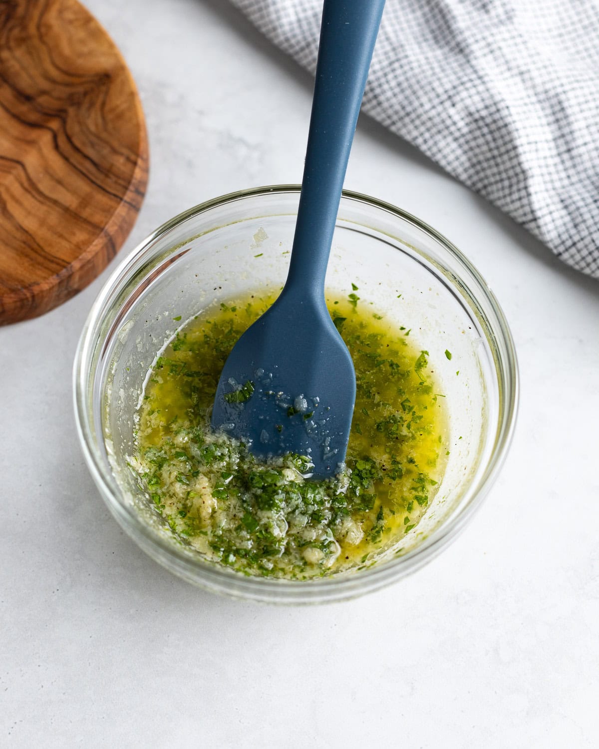Melted butter, olive oil, Parmesan, and spices stirred together in a small bowl.