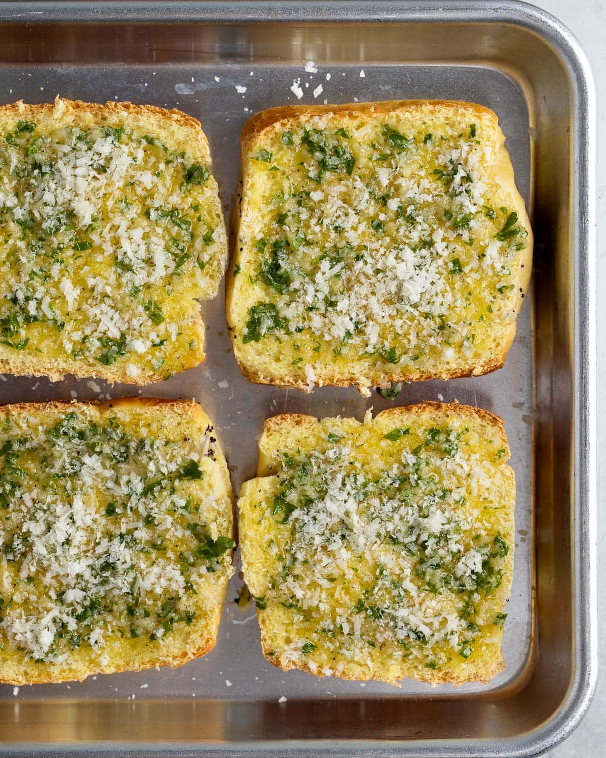 The garlic bread mixture brushed on onion rolls before cooking.