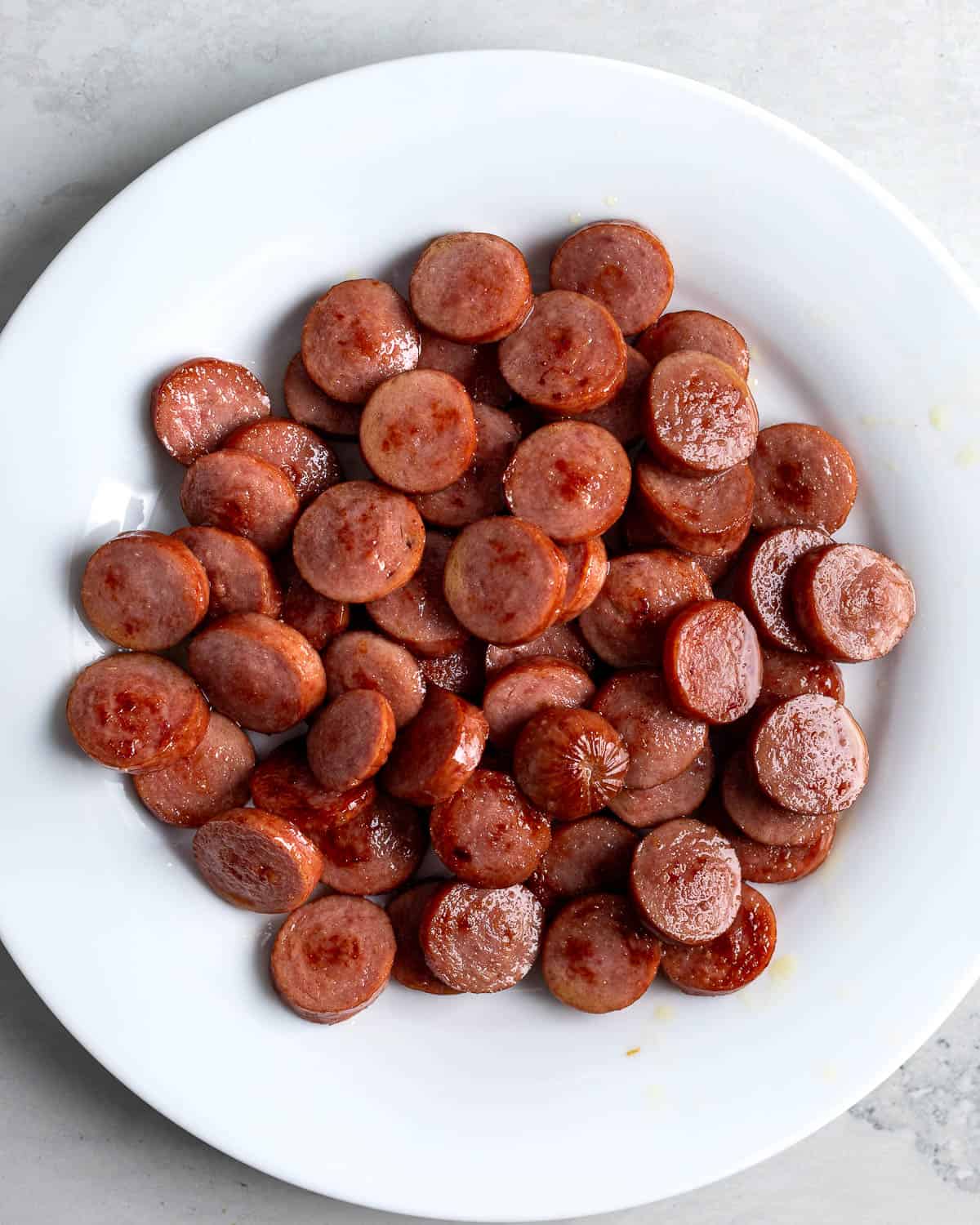 Browned smoked sausage slices on a plate.