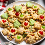 An assortment of spritz cookies on a plate.