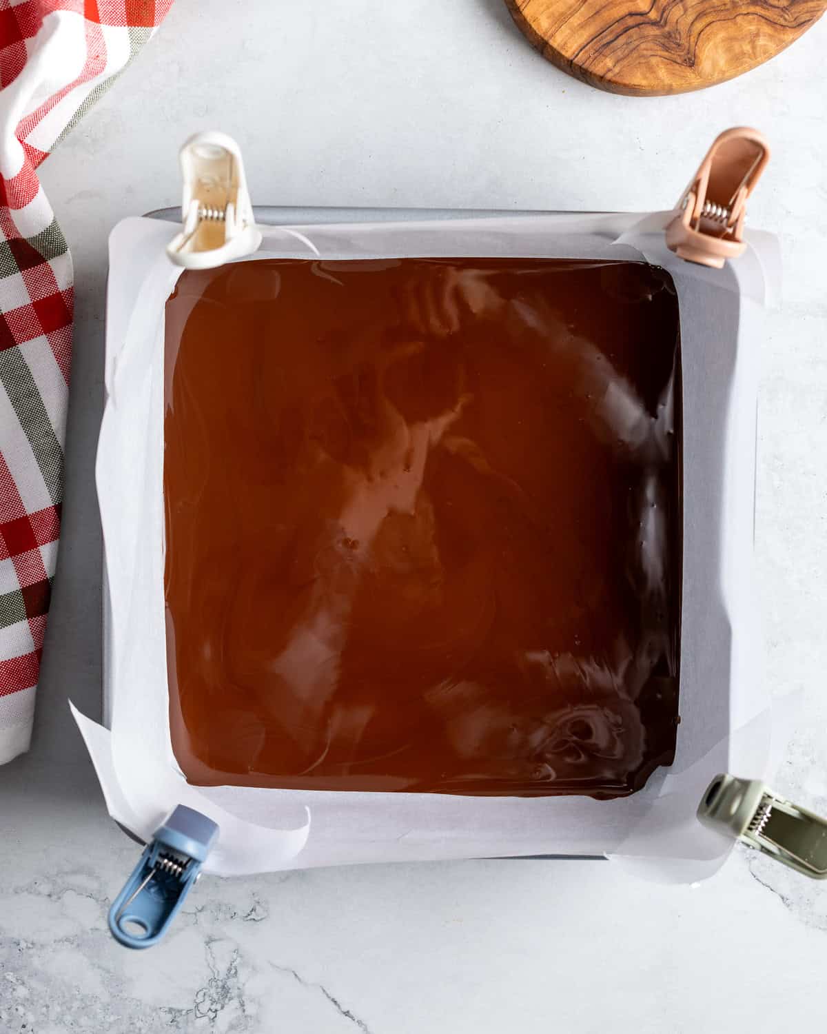 The dark chocolate layer poured into the square pan.