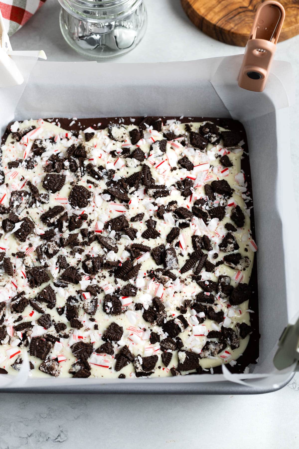 Oreo and candy cane pieces pressed into the white chocolate layer of the bark.