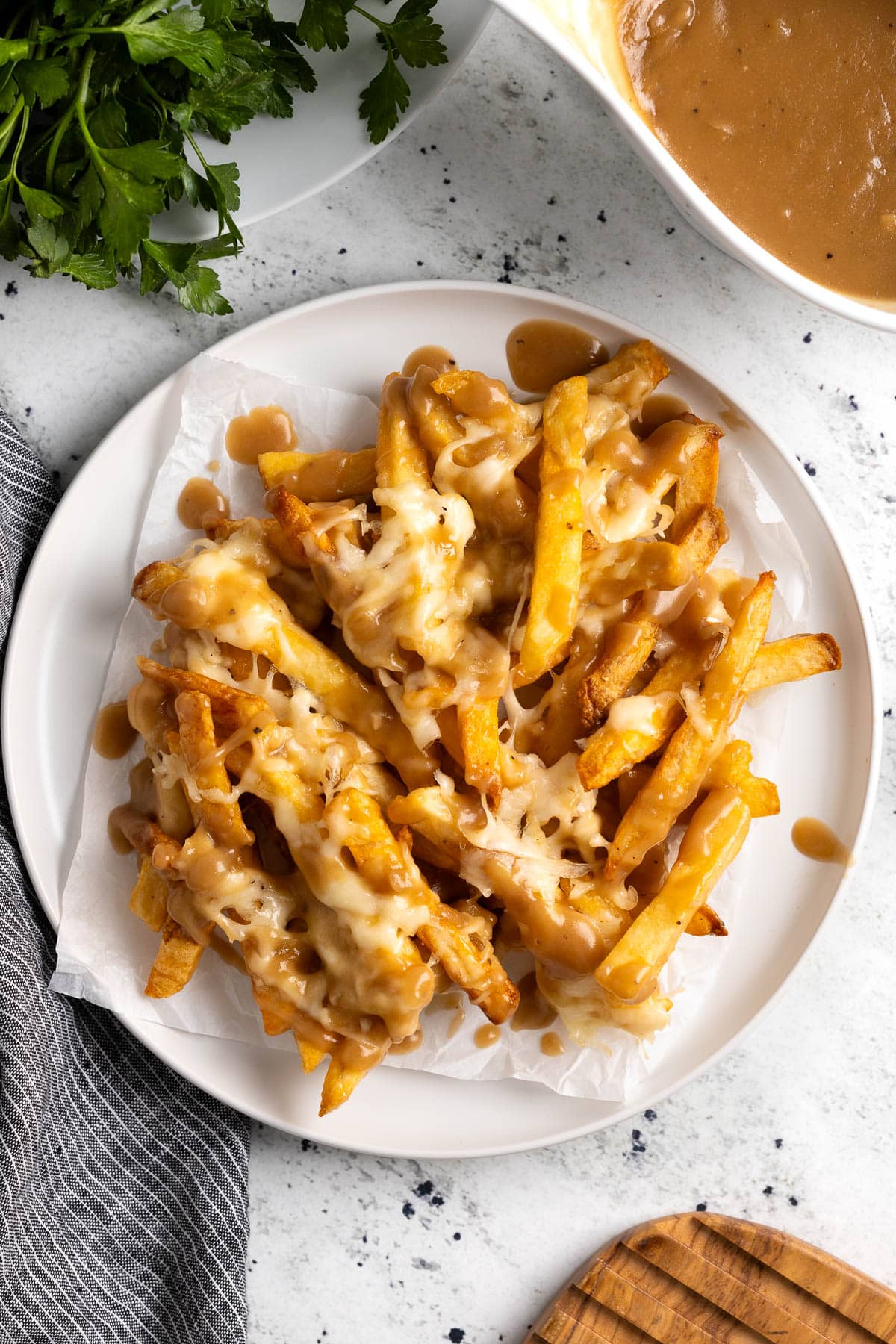 A pile of disco fries on a small plate.