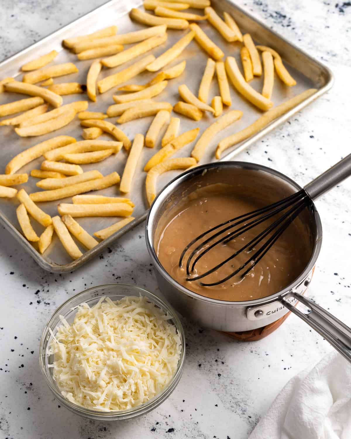 Disco fries ingredients in separate containers.
