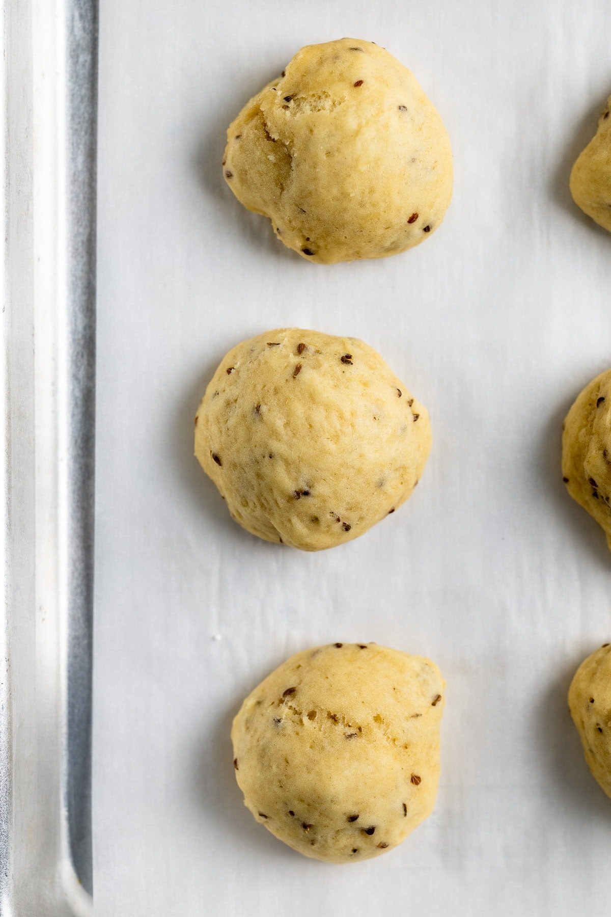 Baked anise cookies speckled with whole anise seeds.