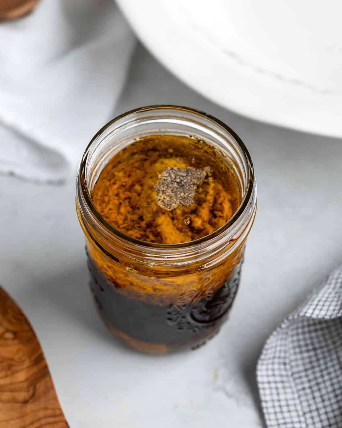 All vinaigrette ingredients poured into a jar.