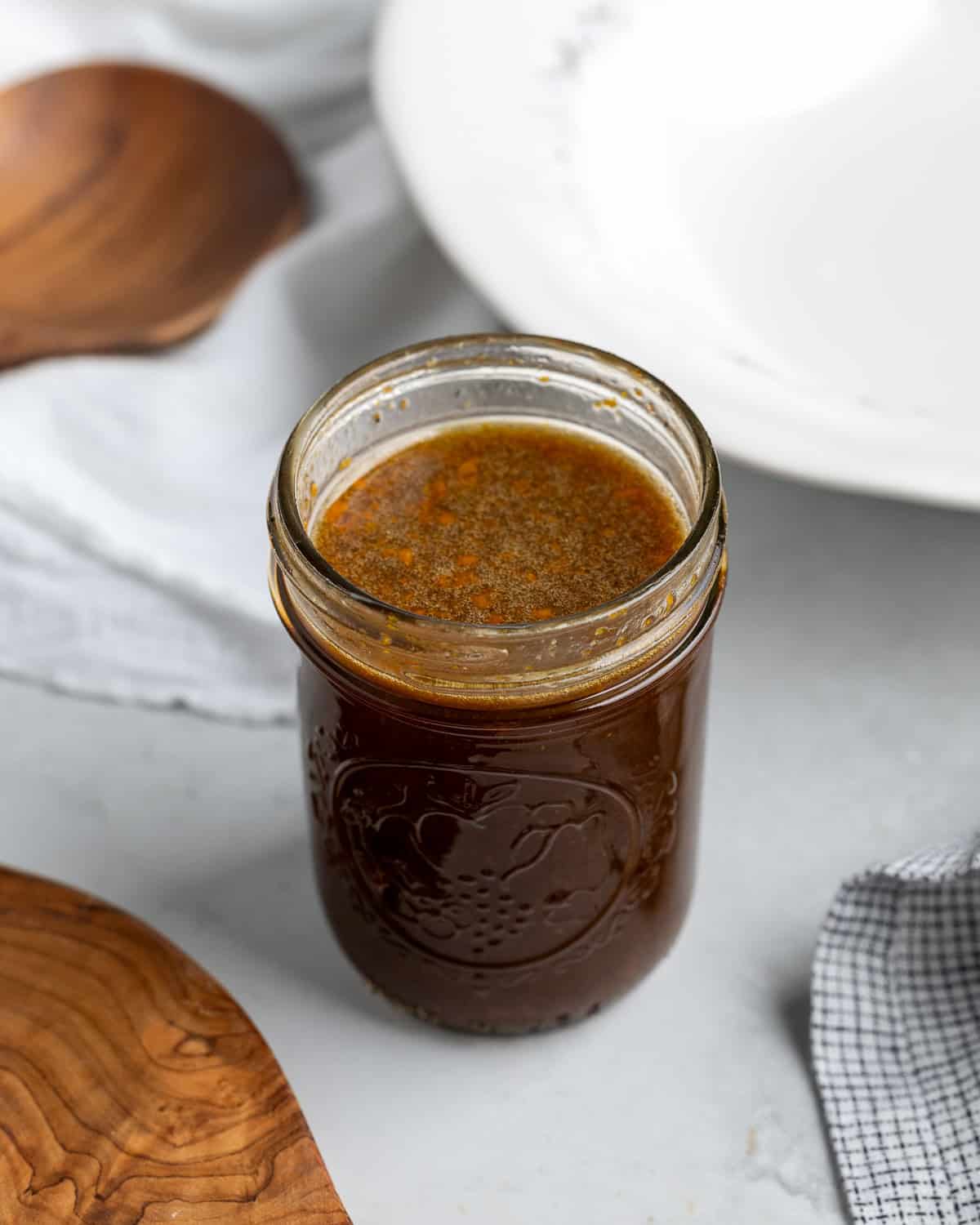 The spinach and arugula salad vinaigrette shaked up and combined in a jar.