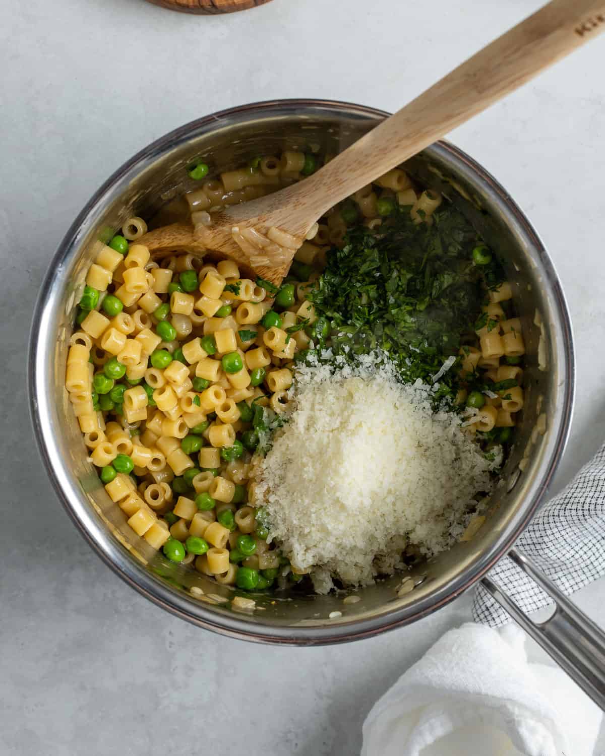 Pecorino and parsley added to the pot to be stirred in to finish the dish.