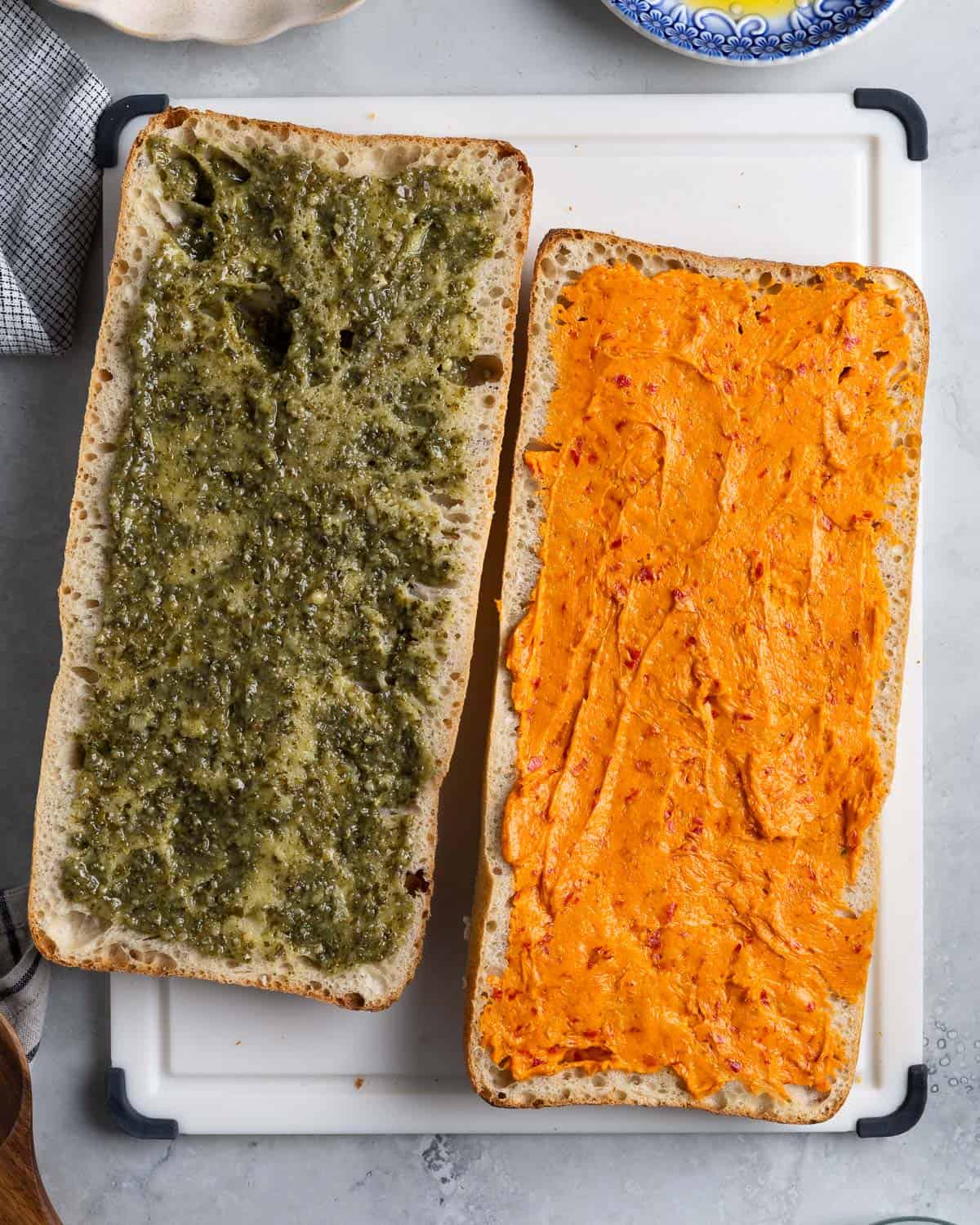 Pesto spread on one half of the bread with Calabrian hot honey butter spread on the other.