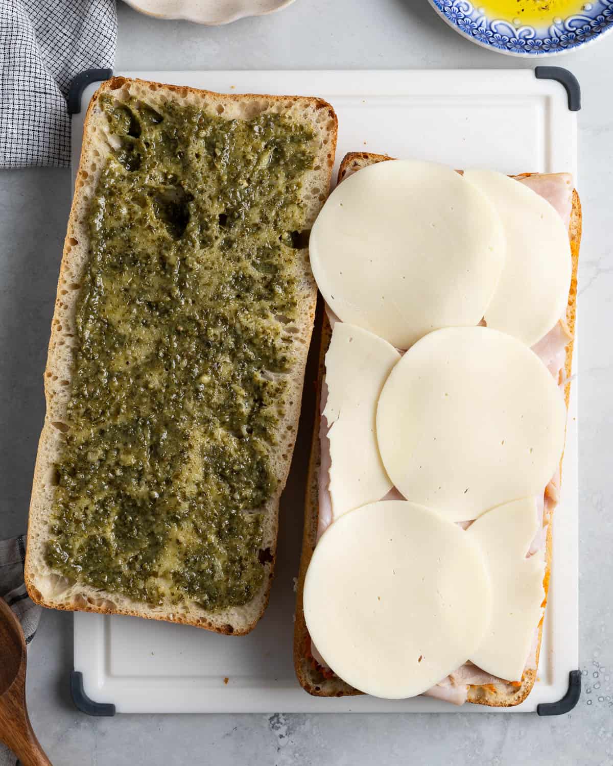 Pesto spread on one half of the loaf and Calabrian butter, turkey, and cheese on the other.