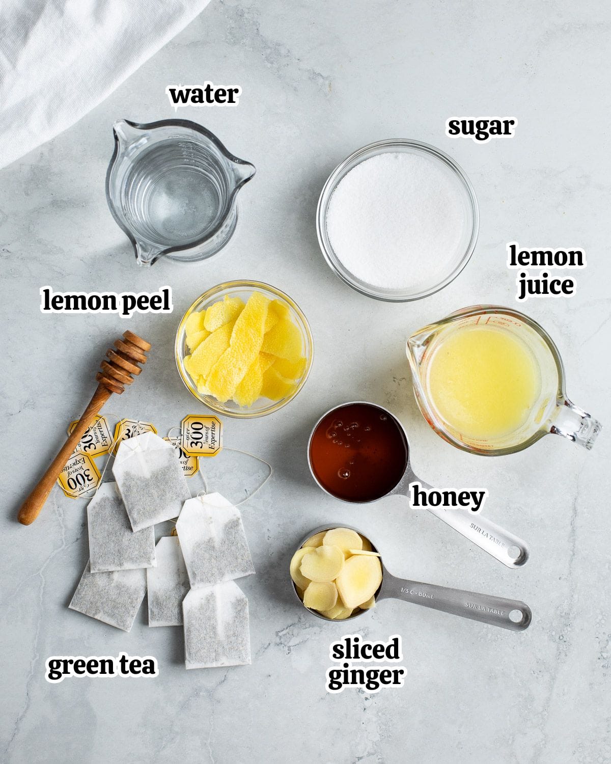 Text-labeled flavored iced green tea ingredients in separate containers.