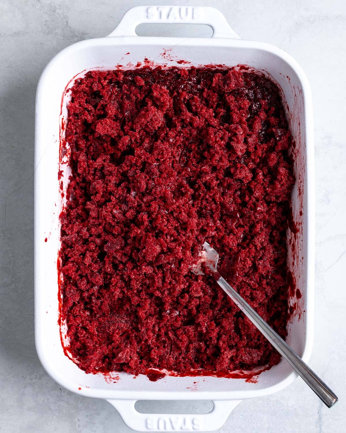 A fork scraping up the icy bits of the granita in the dish.