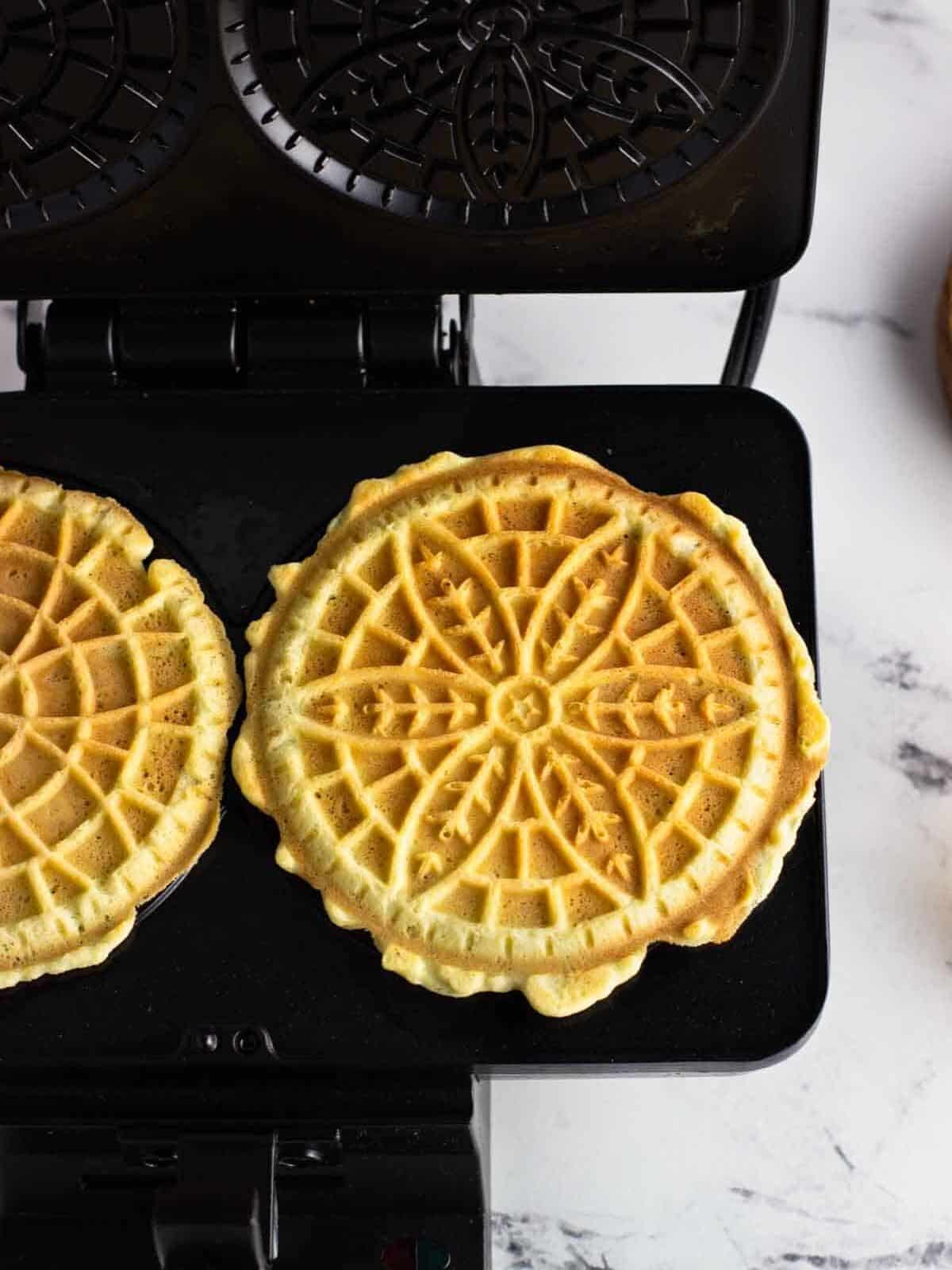 Cooked pizzelle on the pizzelle iron.