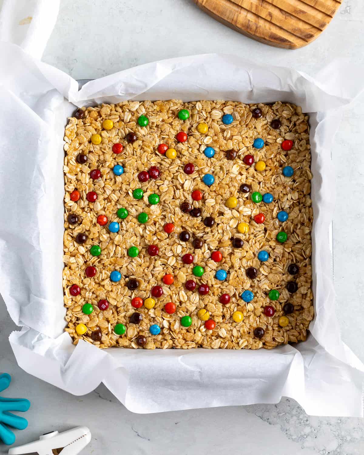 The mixture pressed into the pan with mini M&M'S pressed into the top.