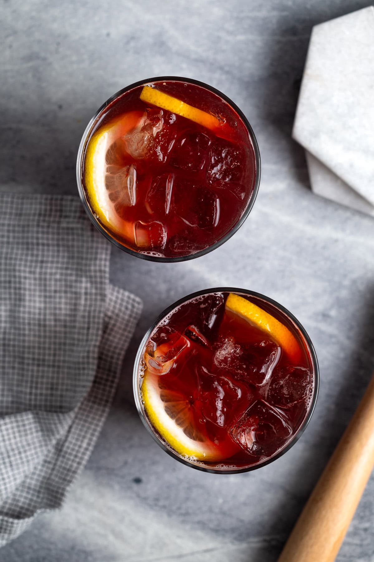 Sparkling red wine cocktails in glasses garnished with orange and lemon rounds.