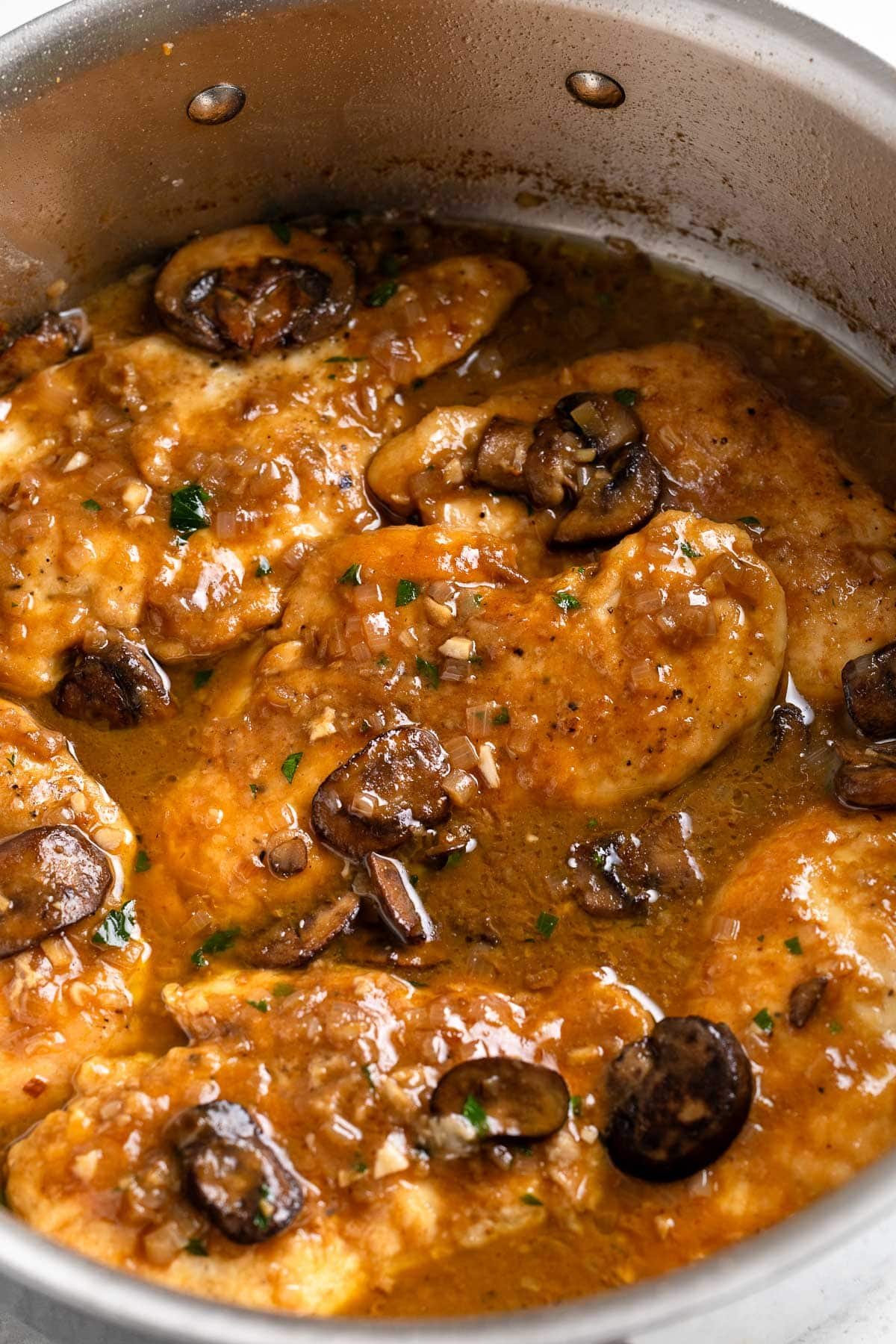 Chicken marsala in a large saute pan.