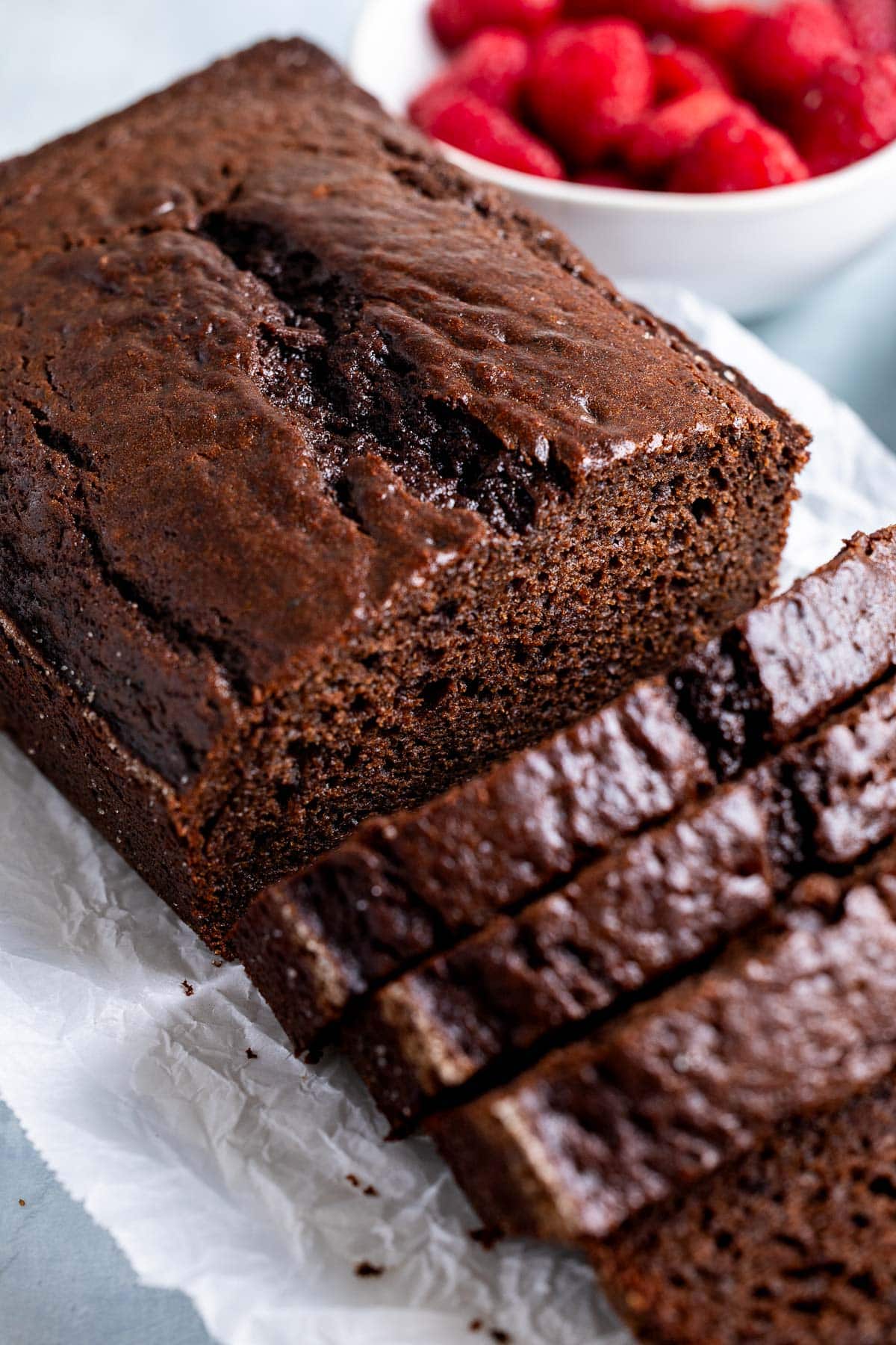 A half-sliced loaf of chocolate yogurt cake.