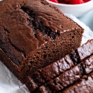 A half-sliced loaf of chocolate yogurt cake.