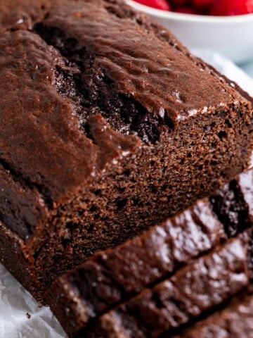 A half-sliced loaf of chocolate yogurt cake.
