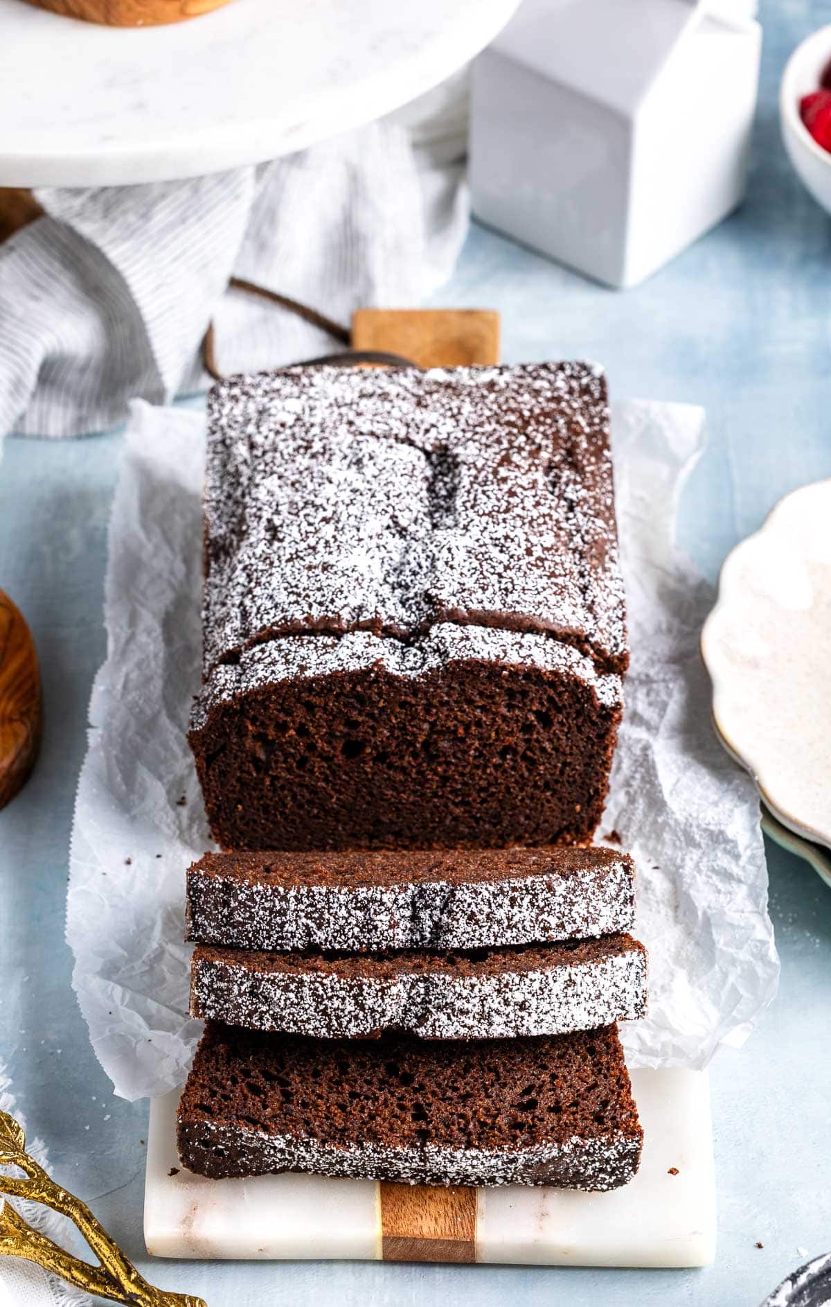 A loaf of chocolate yogurt cake dusted with powdered sugar.