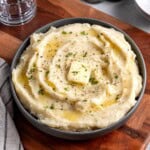 A serving bowl of roasted garlic mashed potatoes.
