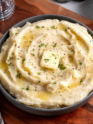 A serving bowl of roasted garlic mashed potatoes.