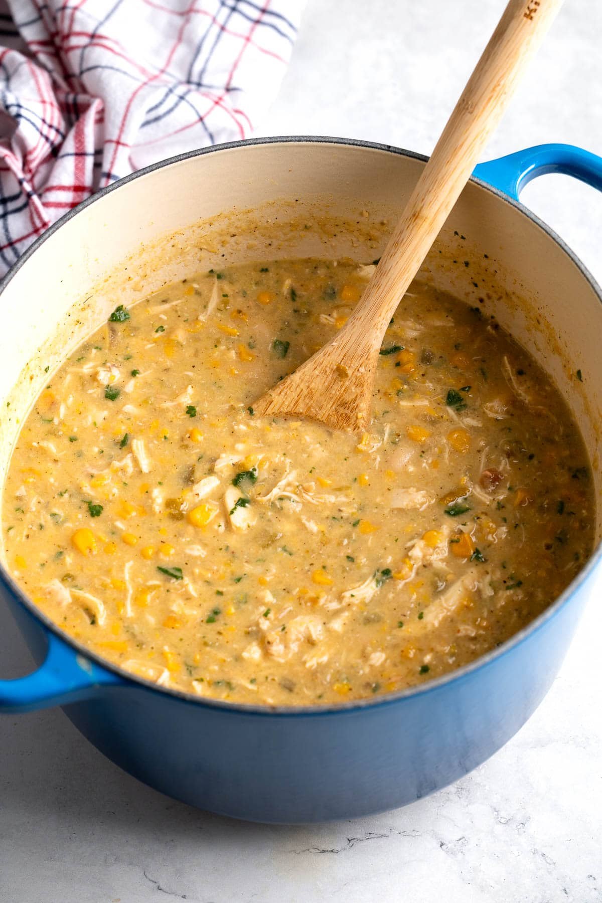 A pot of white chicken chili after stirring in the cheese, cilantro, and lime juice.